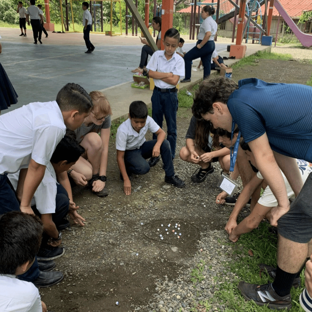 kids in a circle playing marbles