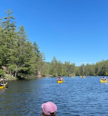 people canoeing on a lake