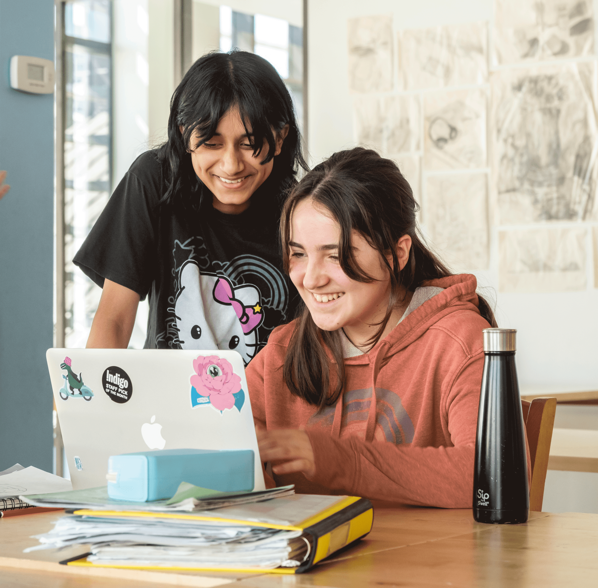 2 kids in front of a laptop learning