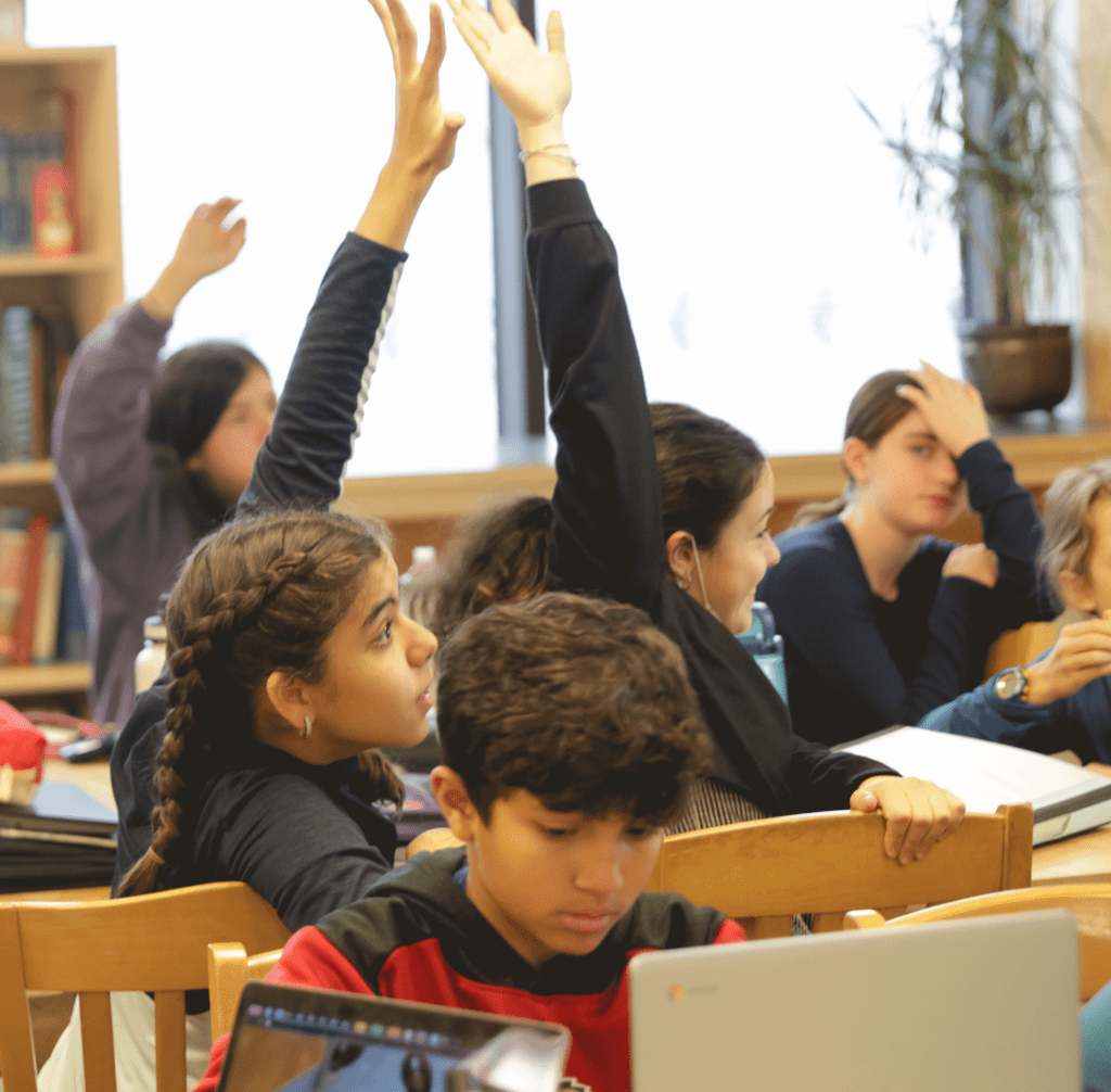 class of students raising their hands