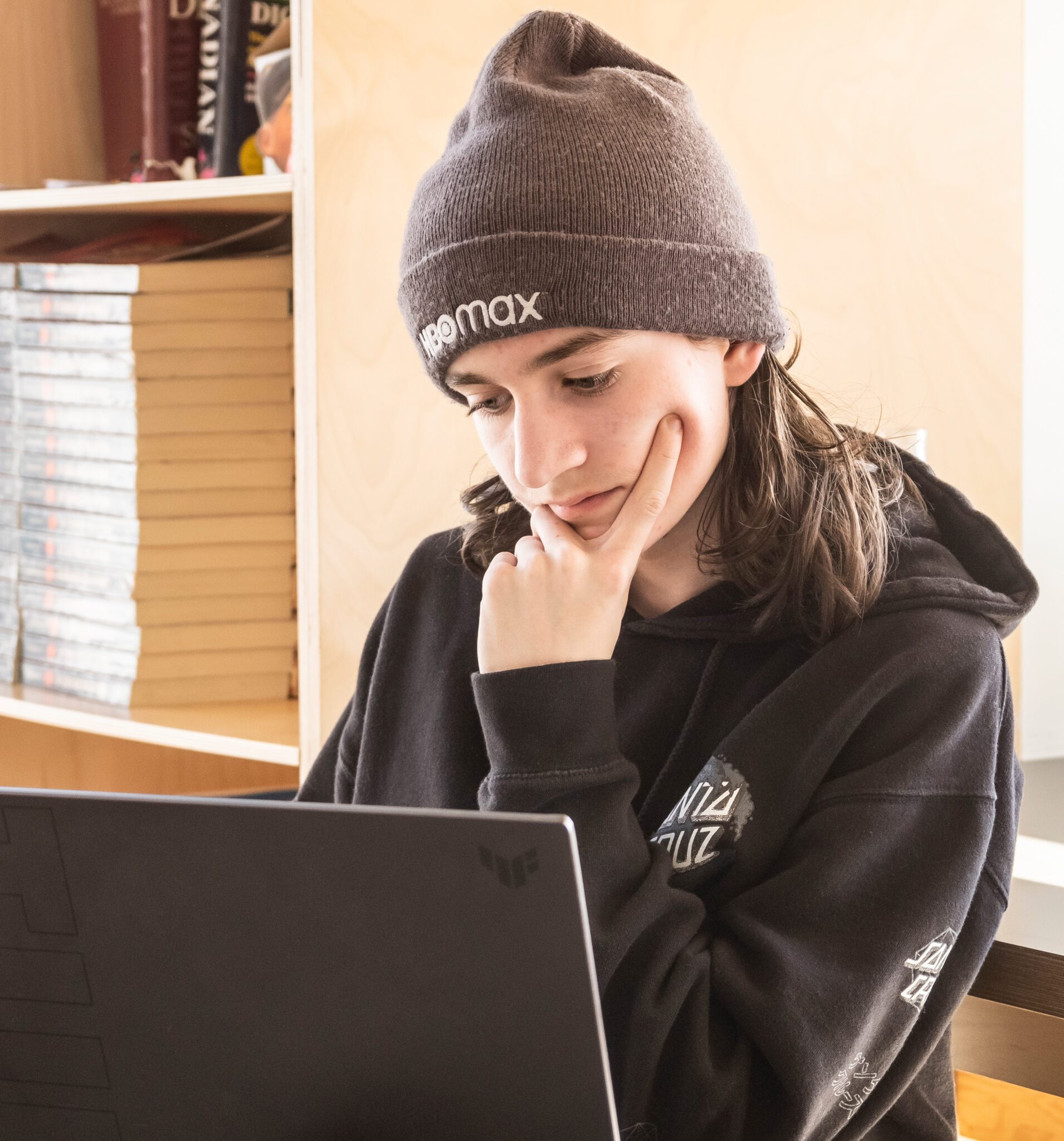 kid in front of laptop thinking